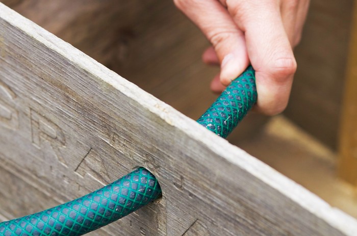 How to make a hedgehog house - inserting a hose for ventilation